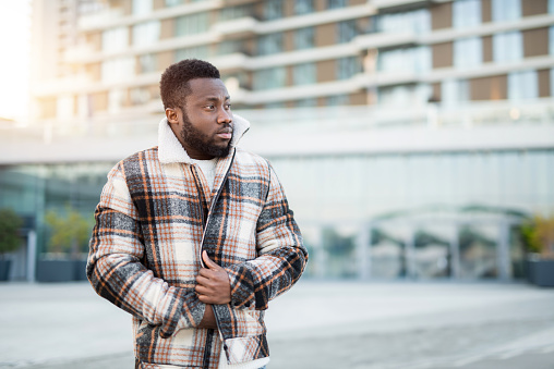 Fashionable man warming up while walking in the city.