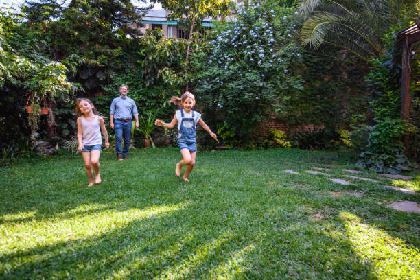 istock Young Sisters and Father Spending Time in Backyard 1221713899