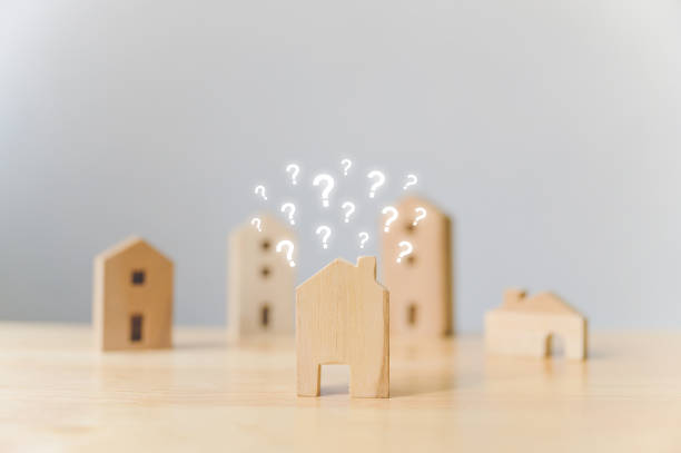 Real estate developer and managing property investment concept. Selective focus wooden houses with question mark on wood table Real estate developer and managing property investment concept. Selective focus wooden houses with question mark on wood table legacy concept photos stock pictures, royalty-free photos & images