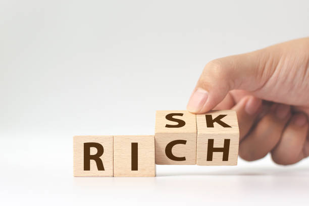 istock Risk or Rich concept, Hand flip wood cube change the word 1221716397