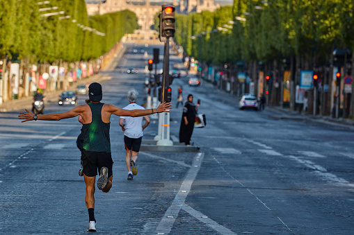 Paris , France - April 26 , 2020 :  Parisians people practicing sport one hour per day allowed during  lock down for coronavirus covid-19 quarantine