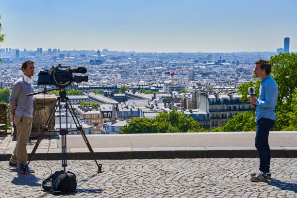 Paris , France - April 26 , 2020 :  Journalists on outdoors set  in Montmartre during the  lock down coronavirus covid-19 quarantine