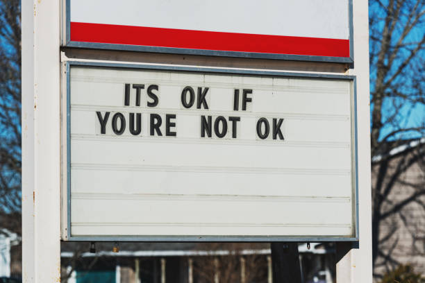 Its OK If You're Not OK A sign of support in the aftermath of a mass shooting in April 2020. mental illness photos stock pictures, royalty-free photos & images