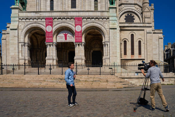 Paris, France - August 29, 2011: One man sit on the stairs and people in front of the Basilica.  The Basilica of the Sacred Heart of Paris, commonly known as Sacre-Coeur Basilica is a Roman Catholic church and minor basilica.