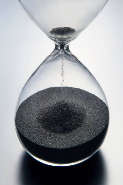 istock Hourglass on a light background. Time is money. Business solutions in time. 1221718869