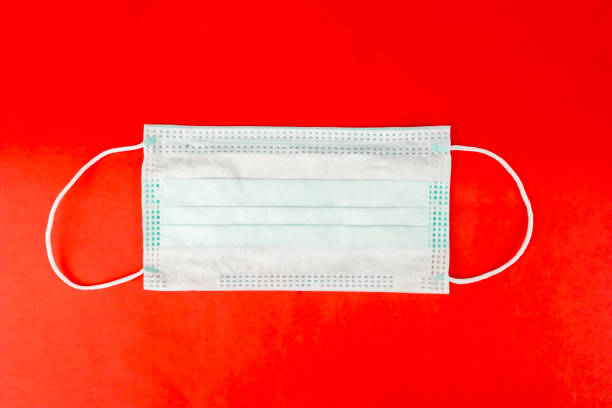 istock Top down view of a face mask isolated in red 1221721849