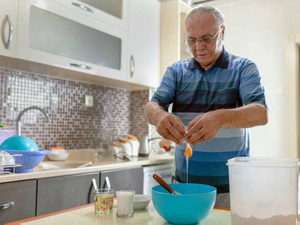 istock senior man learns about culinary work during his quarantine at home 1221722750