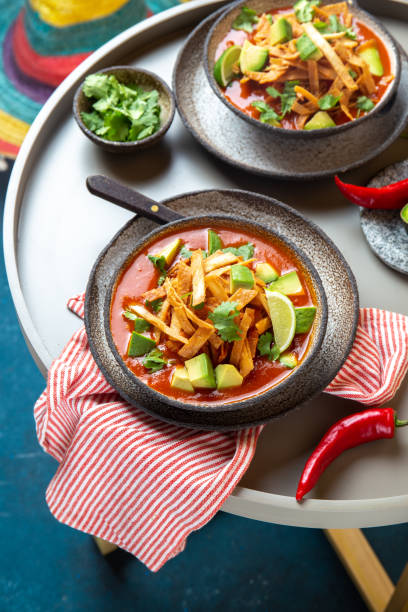 istock Mexican style table with spicy aztec soup with fried tortilla. Sopa azteca 1221723629