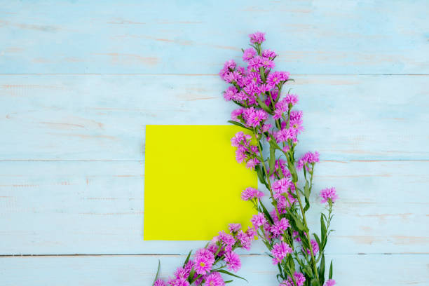 istock Yellow empty paper with purple gerbera flower 1221725363