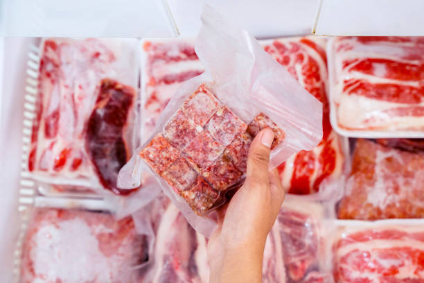 istock Top view of hand picking a pack of cube red meat 1221725387