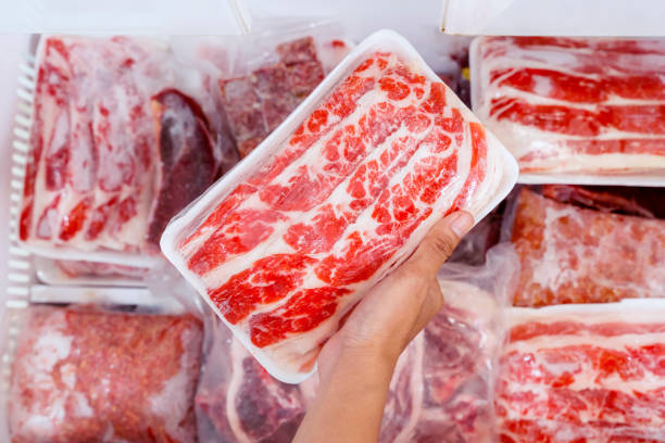istock Top closeup of hand picking big chunk red meat 1221725391