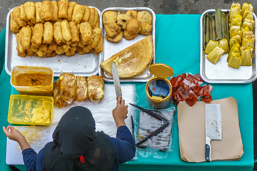 Variety of delicious and colorful Malaysian home cooked local cakes sold at street market stall in Kota Kinabalu Sabah from top angle view.