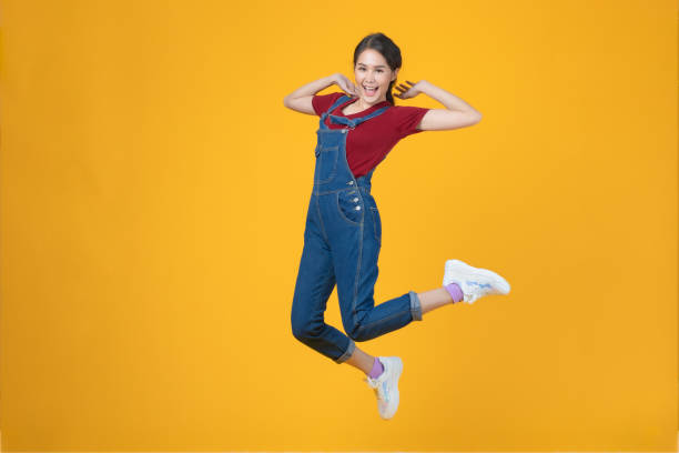 Asian woman jumping by happy face.