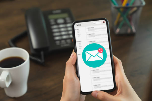 istock Hand holding smartphone and show email screen on application mobile in the office. 1221727952