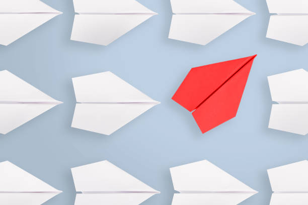 Change concepts with red paper airplane leading among white