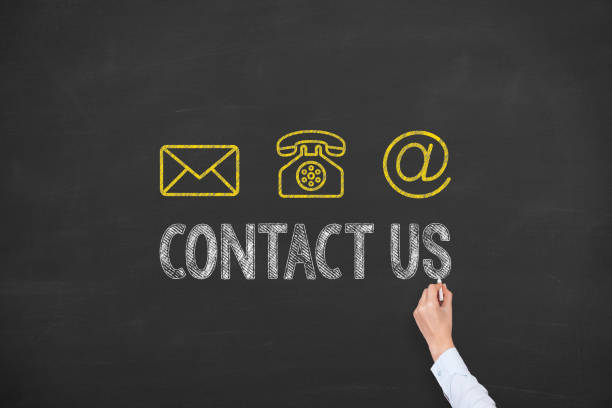 istock Human Hand Drawing Contact Us on Blackboard 1221728018