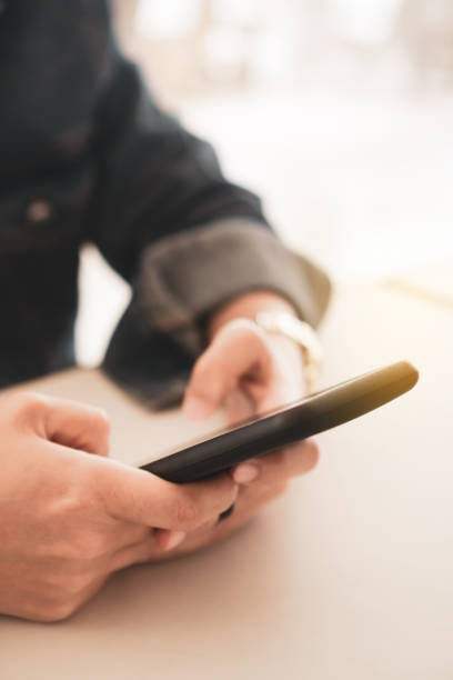 istock Womanhand using smartphone to do work business, social network, communication in public cafe work space area. 1221728693