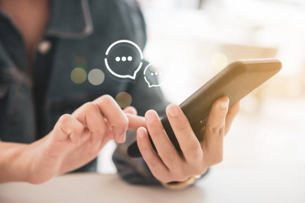 istock Women hand using smartphone typing, chatting conversation in chat box and icons social media app pop up. maketing technology background concept. 1221728726