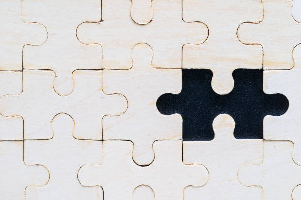 istock Close up wooden jigsaw puzzle pieces on black background 1221729678