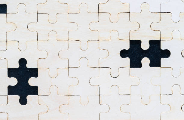 istock Close up wooden jigsaw puzzle pieces on black background 1221729693