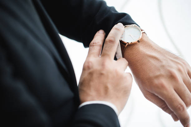 istock Businessman looking at his watch in office 1221731552