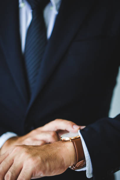istock Businessman looking at his watch in office 1221731619