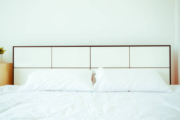istock white pillows and bed sheets in beauty room. Close-up 1221731685