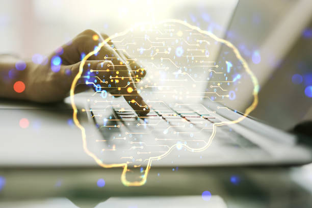 istock Creative artificial Intelligence concept with human brain hologram and hands typing on laptop on background. Multiexposure 1221734361