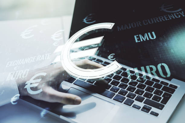istock Creative EURO symbols illustration and hands typing on computer keyboard on background, forex and currency concept. Multiexposure 1221734389