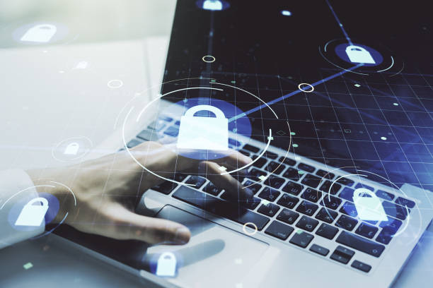 istock Creative idea concept with lock symbol and microcircuit illustration and hands typing on laptop on background. Protection and firewall concept. Multiexposure 1221734390