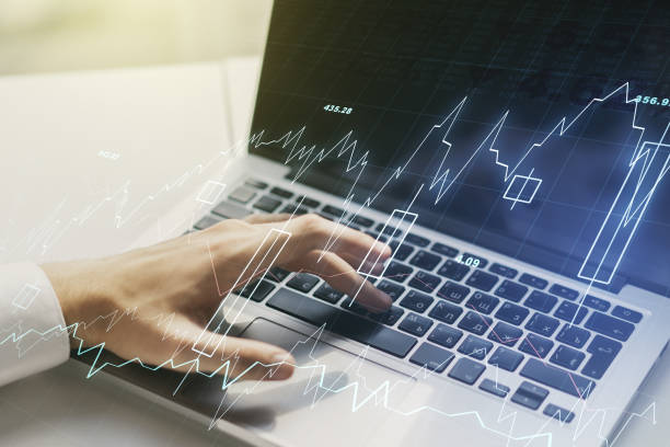 istock Multi exposure of abstract creative financial graph with hand typing on laptop on background, forex and investment concept 1221734406