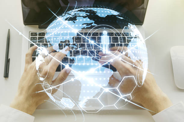 istock Social network media concept with world map and hands typing on computer keyboard on background. Double exposure 1221734975