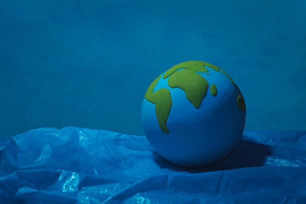 istock earth floating on blue plastic ocean 1221736949
