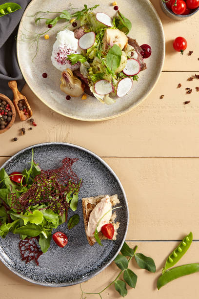 istock Meat salads with vegetables in ceramic plates top view 1221737721