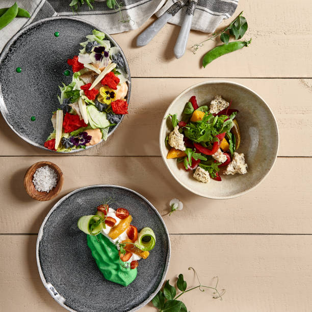istock Fish and vegetables salads in ceramic plates top view 1221737731