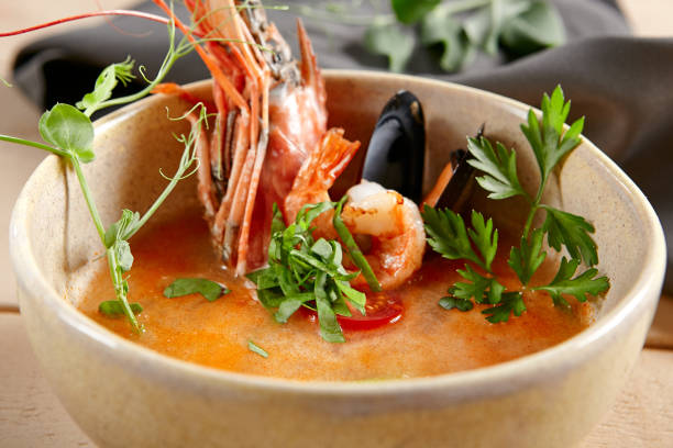 istock Tom yum soup in beige ceramic bowl top view 1221737763