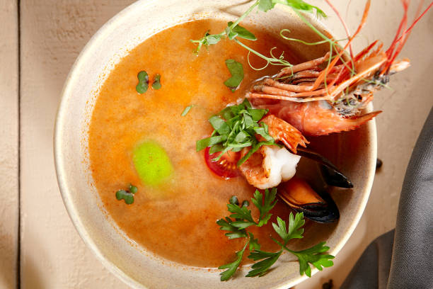 istock Tom yum soup in beige ceramic bowl top view 1221737764