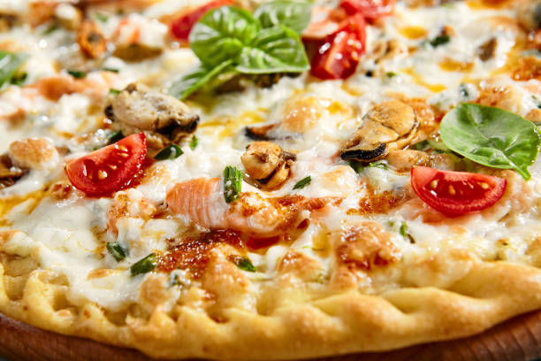 istock Seafood pizza on wooden board 1221737775