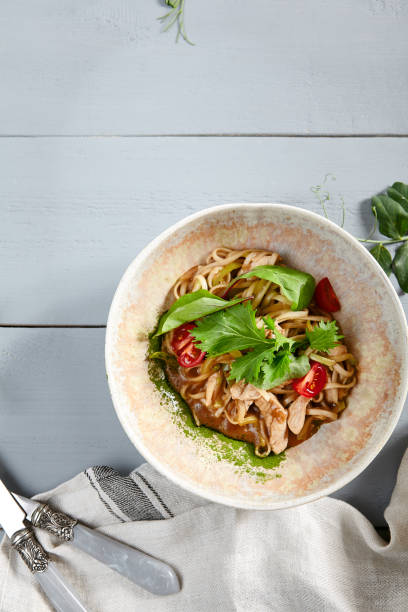 istock Asian noodles with chicken in beige bowl 1221737778