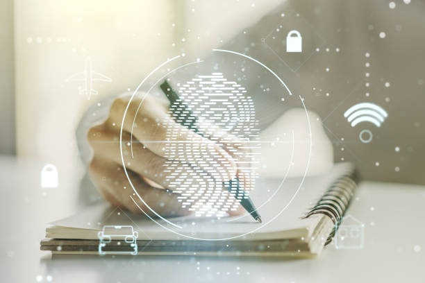 istock Multi exposure of abstract fingerprint scan interface with man hand writing in notepad on background, digital access concept 1221737920