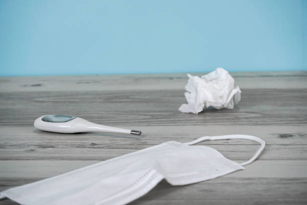 istock Thermometer and mask placed on the table 1221739870