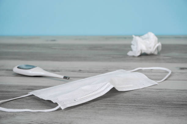 istock Thermometer and mask placed on the table 1221739874