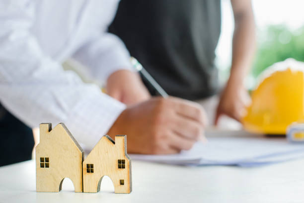 istock Business industrial ,Engineer and Architect concept, Engineer Architects office team working with blueprints and house model 1221740734