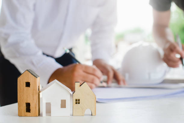 istock Business industrial ,Engineer and Architect concept, Engineer Architects office team working with blueprints and house model 1221740744