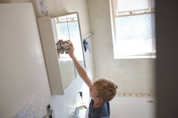 istock Young boy cleaning the bathroom 1221741016