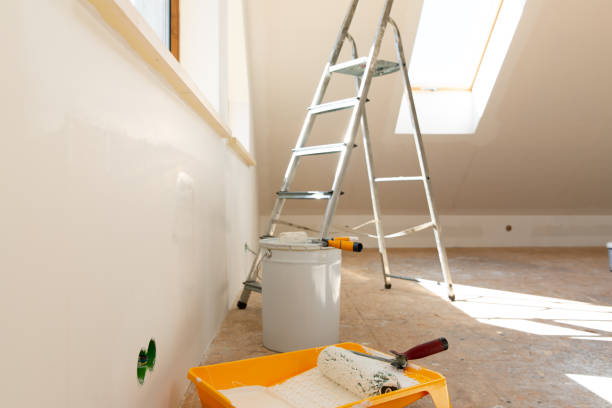 istock Home improvement. Painting tools roller, paint bucket and paintbrush in a natural light. 1221743087
