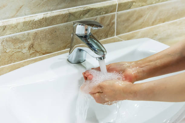 istock Cropped shot of hands being washed at a tap 1221745687
