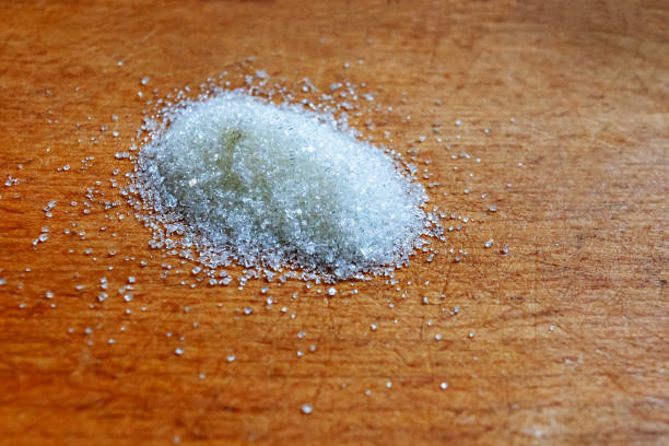 istock Board with sugar on wooden background. 1221745961