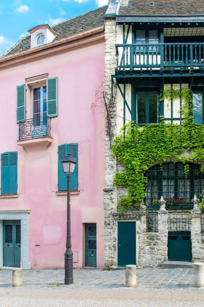 Paris, France, famous pink house Paris, France, famous pink house and buildings in Montmartre, in a typical street place pigalle stock pictures, royalty-free photos & images