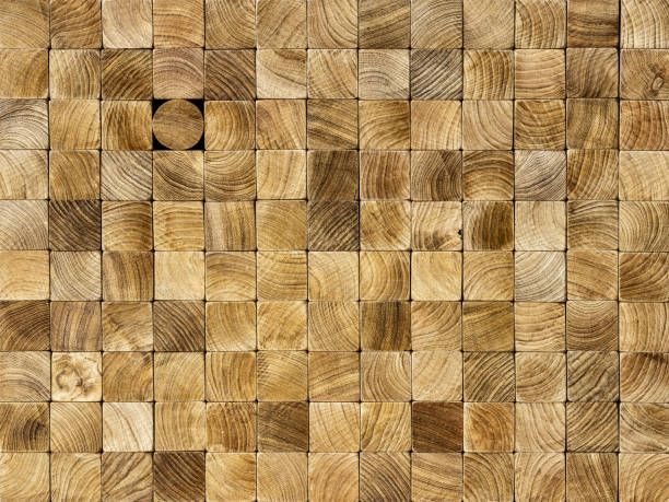 istock Many square wood blocks stacked up with one different round block within the square block background, standing out from the crowd. 1221747003